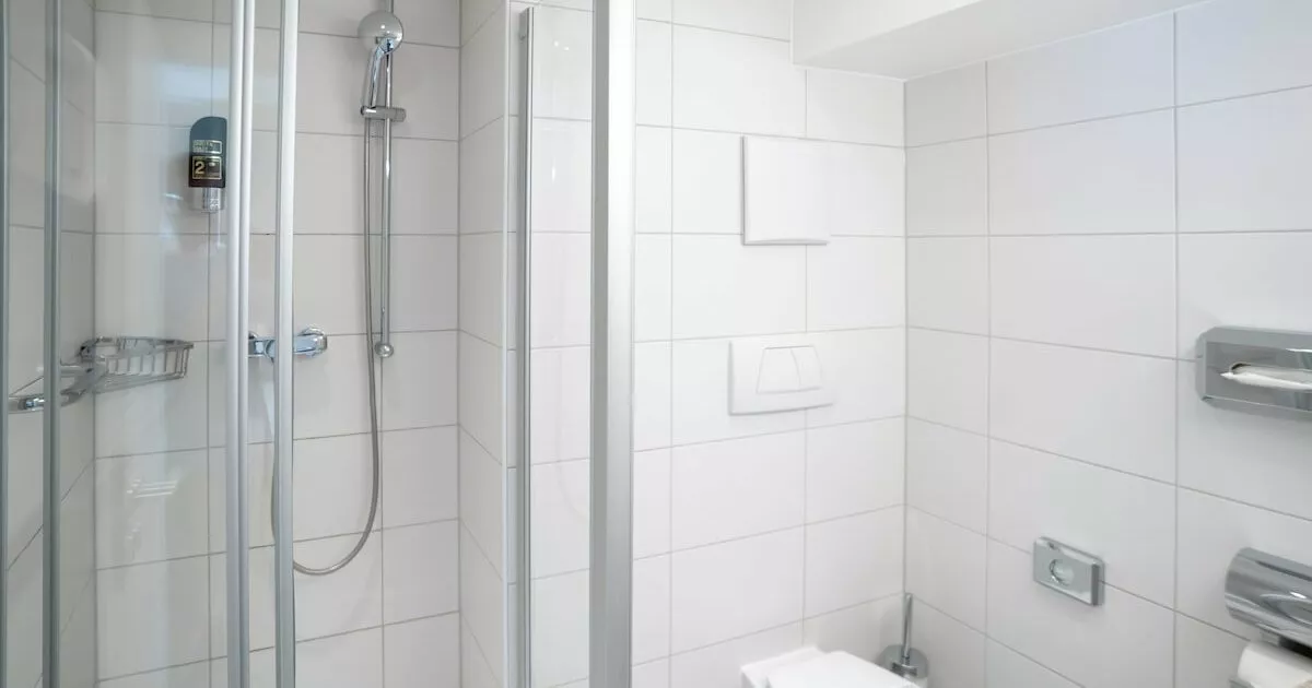 Dusche und Toilette im Badezimmer in einem günstigen Einzelzimmer in München